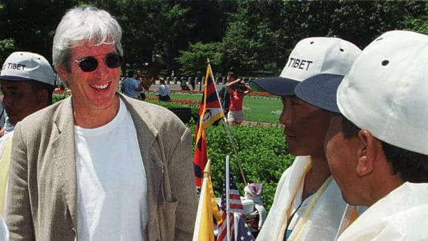 Richard Gere laughs with Tibetan protesters before giving a speech at a rally to free Tibet on July 1st, 2000.