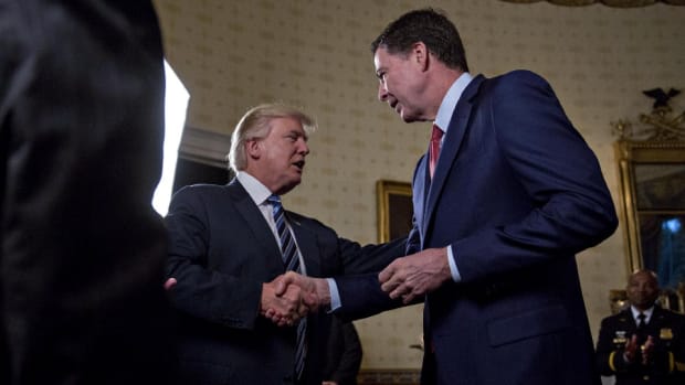 President Donald Trump shakes hands with James Comey, director of the Federal Bureau of Investigation, during an Inaugural Law Enforcement Officers and First Responders Reception in the Blue Room of the White House on January 22nd, 2017, in Washington, D.C.