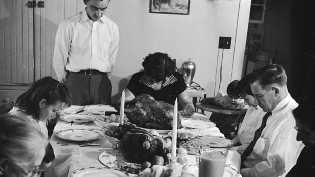 An American family saying pre-Thanksgiving grace, circa 1955.