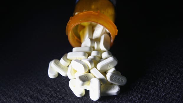 Photo showing pills spilling out of a prescription bottle