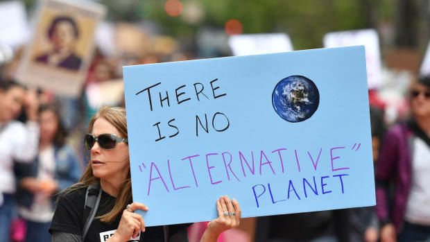 People hold signs during the March for Science in San Francisco, California, on April 22nd, 2017.