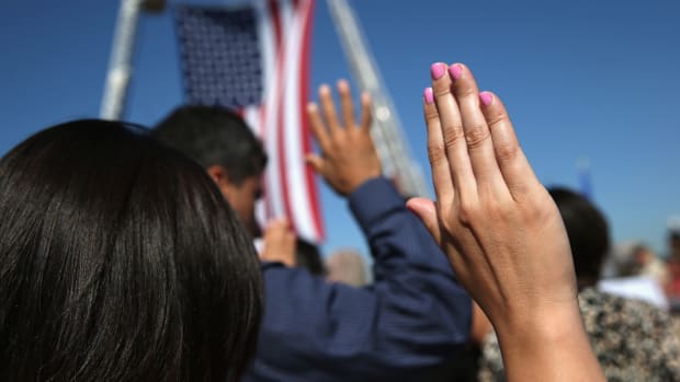 One hundred immigrants become American citizens during a naturalization ceremony at Liberty State Park in Jersey City, New Jersey.