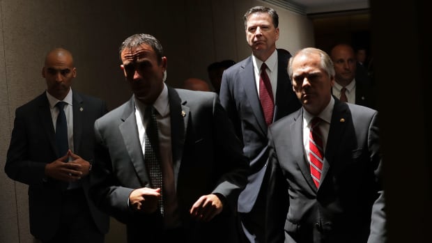 James Comey (second from the right) moves from an open hearing to a closed hearing during a break in testimony before the Senate Intelligence Committee on June 8th, 2017.