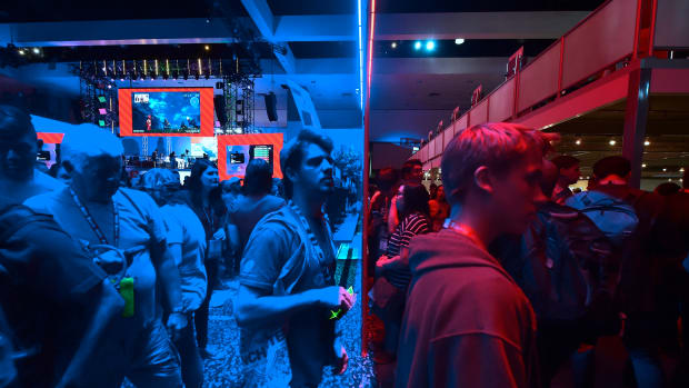 Gaming fans step from the Playstation blue into the Nintendo red display rooms on day one of E3 2017, the three-day Electronic Entertainment Expo, one of the biggest events in the gaming industry calendar, on June 13th, 2017 in Los Angeles, California.