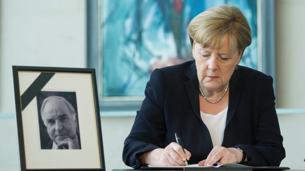 German Chancellor Angela Merkel writes in a condolences book for former chancellor Helmut Kohl on June 18th, 2017, in Berlin, Germany.