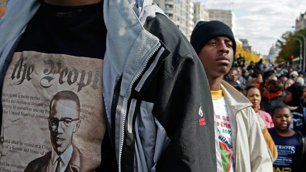 Lloyd Marshall (L) wears a Malcolm X shirt while participating in a march around the Department of Justice to protest hate crimes on November 16th, 2007, in Washington, D.C.
