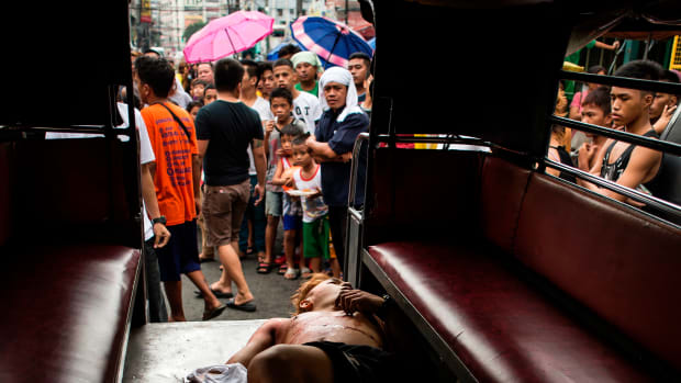 The body of an alleged drug dealer is seen inside a Jeepney after a large-scale anti-drug raid by the police at a slum community in Manila, the Philippines, on July 20th, 2017.