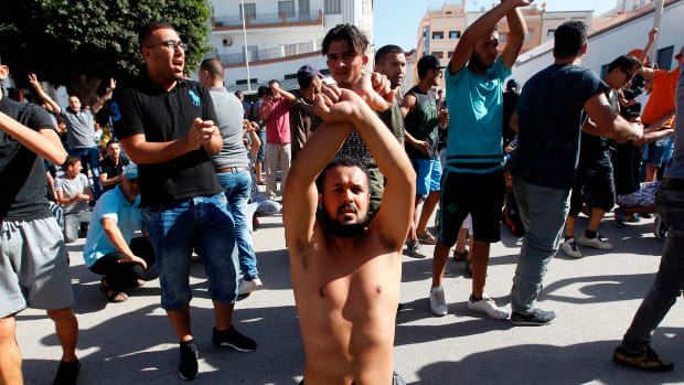 Demonstrators gesture and shout slogans in front of Moroccan security forces during a march in defiance of a government ban in the northern Moroccan city of Hoceima on July 20th, 2017.