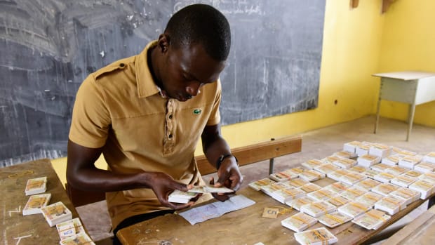 A Senegalese man sorts out voter ID cards in alphabetical order at a school that will be used as a polling station in Dakar on July 26th, 2017, ahead of the country's legislative elections.