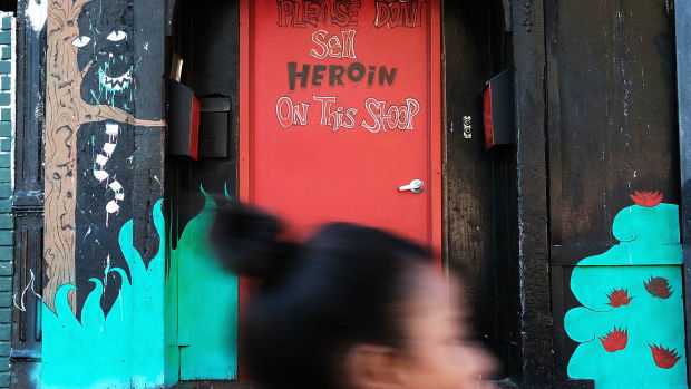 A door is painted with the message to stop selling heroin on a street in a neighborhood in New York City.