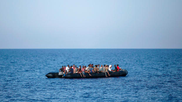 Migrants wait to be rescued by Italian coast guard in the Mediterranean Sea, 30 nautical miles from the Libyan coast, on August 6th, 2017.
