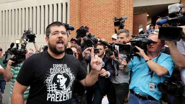 Matthew Heinbach (L) of the white nationalist Traditionalist Workers Party shouts at journalists gathered outside the Charlottesville General District Court building on August 14th, 2017, in Charlottesville, Virginia.