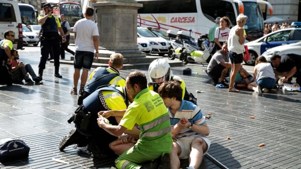 Medics and police tend to injured people near the scene of a terrorist attack in Barcelona, Spain, on August 17th, 2017.