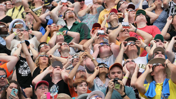 People watch the solar eclipse at Saluki Stadium on the campus of Southern Illinois University on August 21st, 2017, in Carbondale, Illinois. Although much of it was covered by a cloud, with approximately 2 minutes 40 seconds, the area in southern Illinois experienced the longest duration of totality during the eclipse.