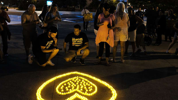 People attend a candlelight vigil for victims of drug addiction on August 24th, 2017, in the borough of Staten Island in New York City. Dozens of Staten Island residents attended the evening vigil which celebrated the lives and gave remembrance to those that have died from drug addiction.