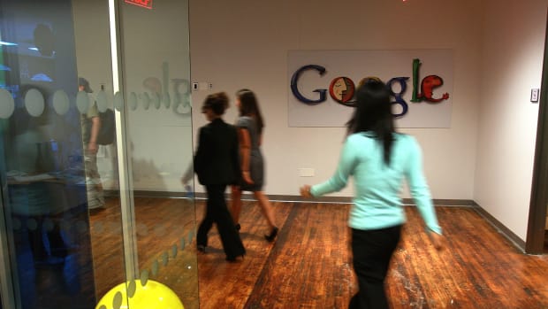 Employees of Google walk down a hallway at the New York office in 2008.
