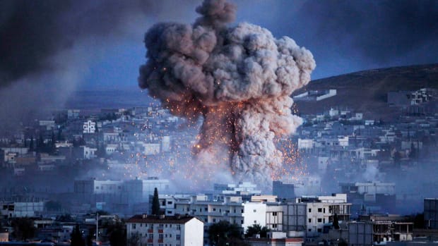 An explosion rocks Kobani, Syria, during a reported suicide car bomb attack by the ISIS militants on October 20th, 2014.