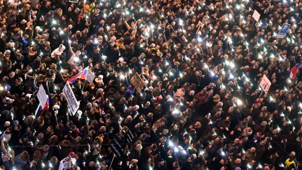 People gather near the Slovak National Uprising square on March 9th, 2018, during a rally against alleged political corruption, where they pay tribute to murdered Slovak journalist Jan Kuciak and his fiancee Martina Kusnirova in Bratislava, Slovakia.