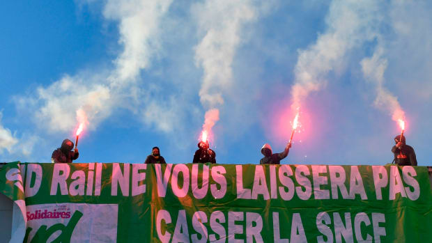 Members of a railway union hold flares during a protest against the reform of the French state-owned railway company SNCF in Paris, France, on March 12th, 2018.