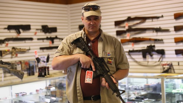 Shop owner Jeff Binkley displays an AR-15 'Sport' rifle at Sarge's Sidearms on September 29, 2016 near Benson, Arizona. He said he redesigned and renamed his store just this year. Gun shops are proliferate in Arizona, which regulates and restricts weapons less than anywhere in the United States.