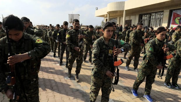 Members of the Kurdish People's Protection Units and Women's Protection Units attend the funeral of Kurdish fighters from the Syrian Democratic Forces that were killed in combat against the Islamic State.