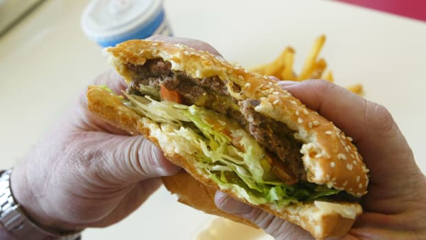A man prepares to bite into a double cheeseburger at Majors Hamburgers, in Yakima, Washington.