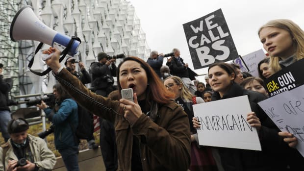 Protesters carry placards and shout slogans during a demonstration calling for greater gun control outside the U.S. Embassy in south London on March 24th, 2018.