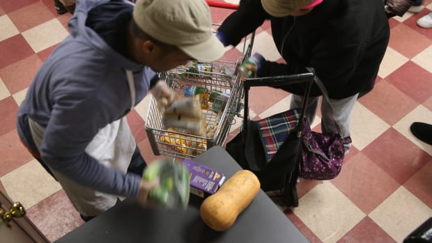 Harlem residents pack free groceries at the Food Bank For New York City on December 11th, 2013, in New York City.