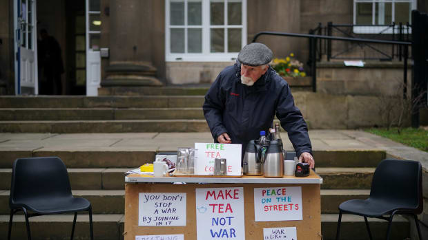 Quaker Alan Pinch makes tea for passersby as he holds a protest against war and military action in Syria on April 12th, 2018, in Manchester, England.