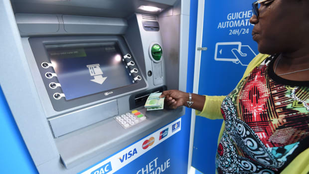 A woman uses an Ecobank Ivory Coast cash dispenser on September 18th, 2017.