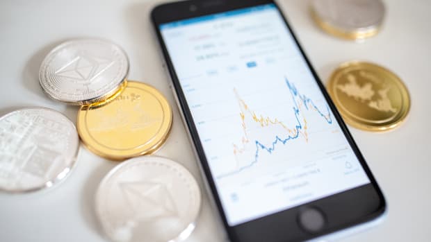In this photo illustration of the litecoin, ripple and ethereum cryptocurrency "altcoins" sit arranged for a photograph beside a smartphone displaying the current price chart for ethereum on April 25th, 2018, in London, England. Cryptocurrency markets began to recover this month following a massive crash during the first quarter of 2018, seeing more than $550 billion wiped from the total market capitalization.