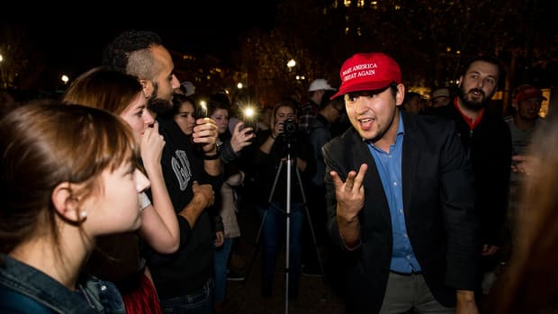 Donald Trump and Hillary Clinton supporters argue in front of the White House while waiting for election results on November 9th, 2016, in Washington, D.C.