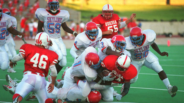Football players from Odessa High School and Dallas Skyline High School play on September 1st, 2000, in Odessa, Texas.