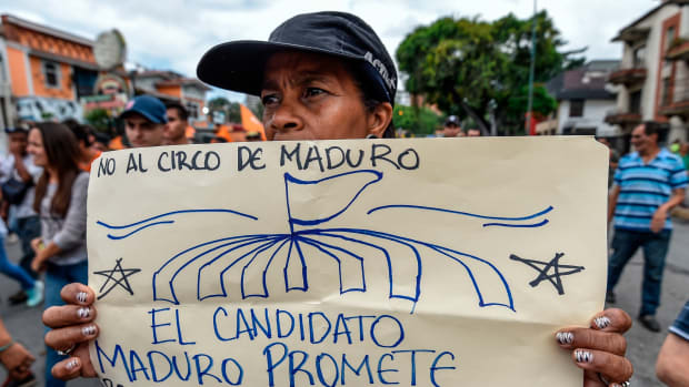 "No to the Maduro circus. The candidate Maduro promises to solve the problems that the President Maduro could not." An opponent of Venezuelan President Nicolas Maduro demonstrates in front of the Organization of American States offices in Caracas on May 16th, 2018.