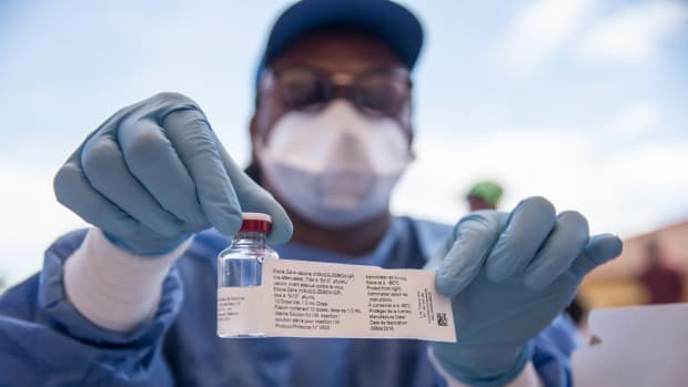 A nurse working with the World Health Organization shows a bottle containing Ebola vaccine at the town hall of Mbandaka on May 21st, 2018, during the launch of the Ebola vaccination campaign. The death toll in an outbreak of Ebola in the Democratic Republic of Congo rose to 26 on May 21st, 2018, after a person died in the northwest city of Mbandaka, as the government began vaccinating first responders against the dreaded disease.