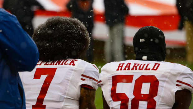 Colin Kaepernick and Eli Harold of the San Francisco 49ers kneel for the national anthem at Soldier Field in Chicago, Illinois, on December 4th, 2016.