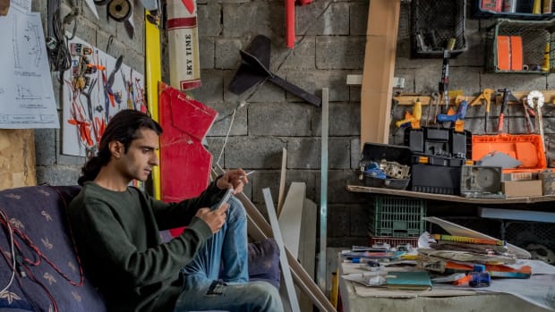 Ari Kamil sits inside his third-floor workshop in Sulaymaniyah, Iraq.