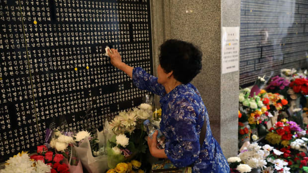 A South Korean woman touches the engraved name of her older brother who died during the Korean War at Seoul National Cemetery on June 6th, 2018, in Seoul, South Korea. South Korean President Moon Jae-in said on Wednesday that his country will push for recovery of remains of the fallen soldiers who died during the 1950-53 Korean War. South Korea marked its 63rd Memorial Day anniversary amid emerging improved relations with the Democratic People's Republic of Korea as the first-ever U.S.-DPRK summit has been scheduled for June 12th in Singapore.