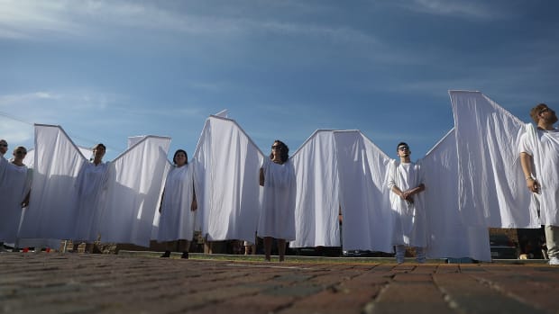 People dressed as angels stand in front of the memorial set up for the shooting victims at Pulse nightclub on June 12th, 2018, where the shootings took place two years ago in Orlando, Florida.