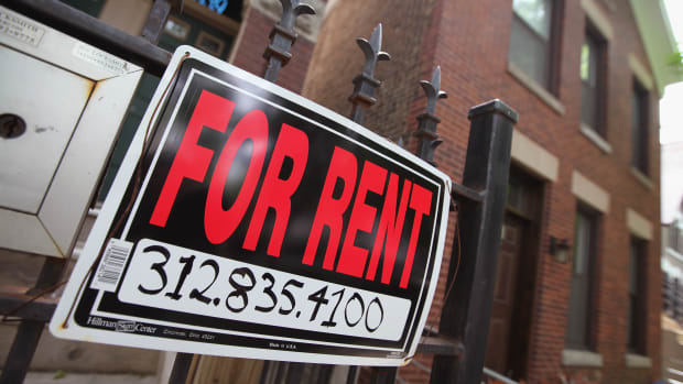 A For Rent sign stands in front of a house on in Chicago, Illinois.