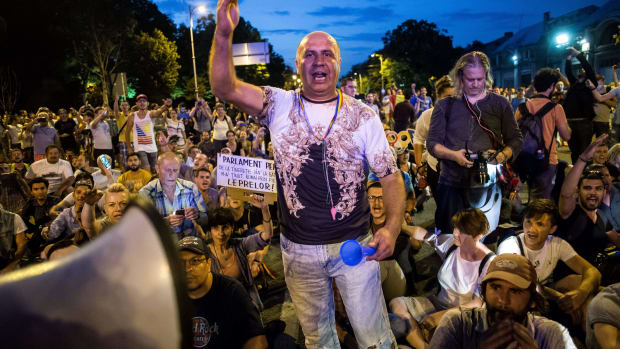 People participate in a protest in front of the prime minister's office in Bucharest on June 20th, 2018, against corruption and recent changes to the penal code which, they say, would severely impede the fight against corruption. Protesters chanted "We will not give in" and "Thieves."