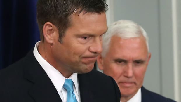 Kansas Secretary of State Kris Kobach (L) and U.S. Vice President Mike Pence attend the first meeting of the Presidential Advisory Commission on Election Integrity in the Eisenhower Executive Office Building.
