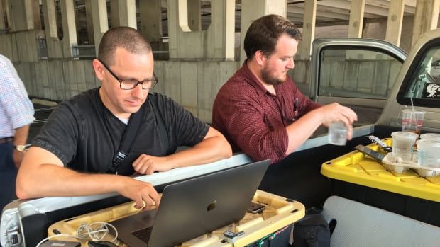 Capital Gazette reporter Chase Cook (right) and photographer Joshua McKerrow work on the next day's issue while awaiting news from their colleagues in Annapolis, Maryland, on June 28th, 2018.