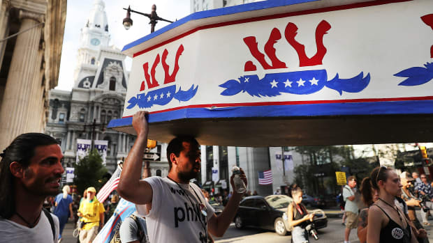 Protesters hold a wooden coffin with an upside down donkey representing the Democratic Party in downtown Philadelphia during the Democratic National Convention on July 26th, 2016, in Philadelphia, Pennsylvania.
