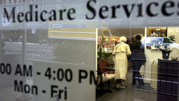 Two people walk inside a Medicare Services office in New York City.