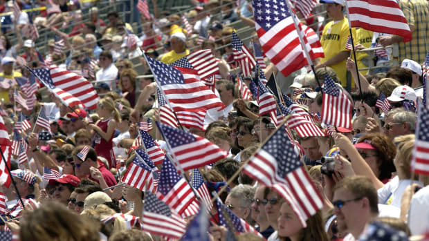 Supporters wave U.S. flags as they attend the Rally for America event at Marshall University stadium on May 24th, 2003, in Huntington, West Virginia.