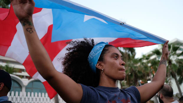A woman displays the Puerto Rican flag in in San Juan, Puerto Rico, on May 2nd, 2018.
