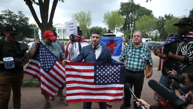 Jason Kessler (center), who organized the Unite the Right rally, speaks on August 12th, 2018, in Washington, D.C.