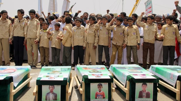 Yemeni children vent anger against Riyadh, Saudi Arabia, and Washington, D.C., on August 13th, 2018, as they take part in a mass funeral in the northern Yemeni city of Saada, a stronghold of the Iran-backed Huthi rebels, for children killed in an airstrike by the Saudi-led coalition last week. At least 29 children were among those killed in the air raid on August 9th on a bus in a crowded market in Dahyan, Saada province, according to the International Committee of the Red Cross.