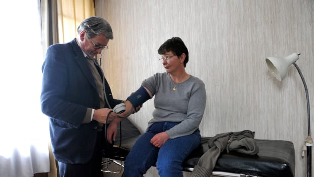 Pierre Brunie, a family doctor, examines a patient at his office, on January 29, 2013 in Eglisneuve-d'Entraigue.